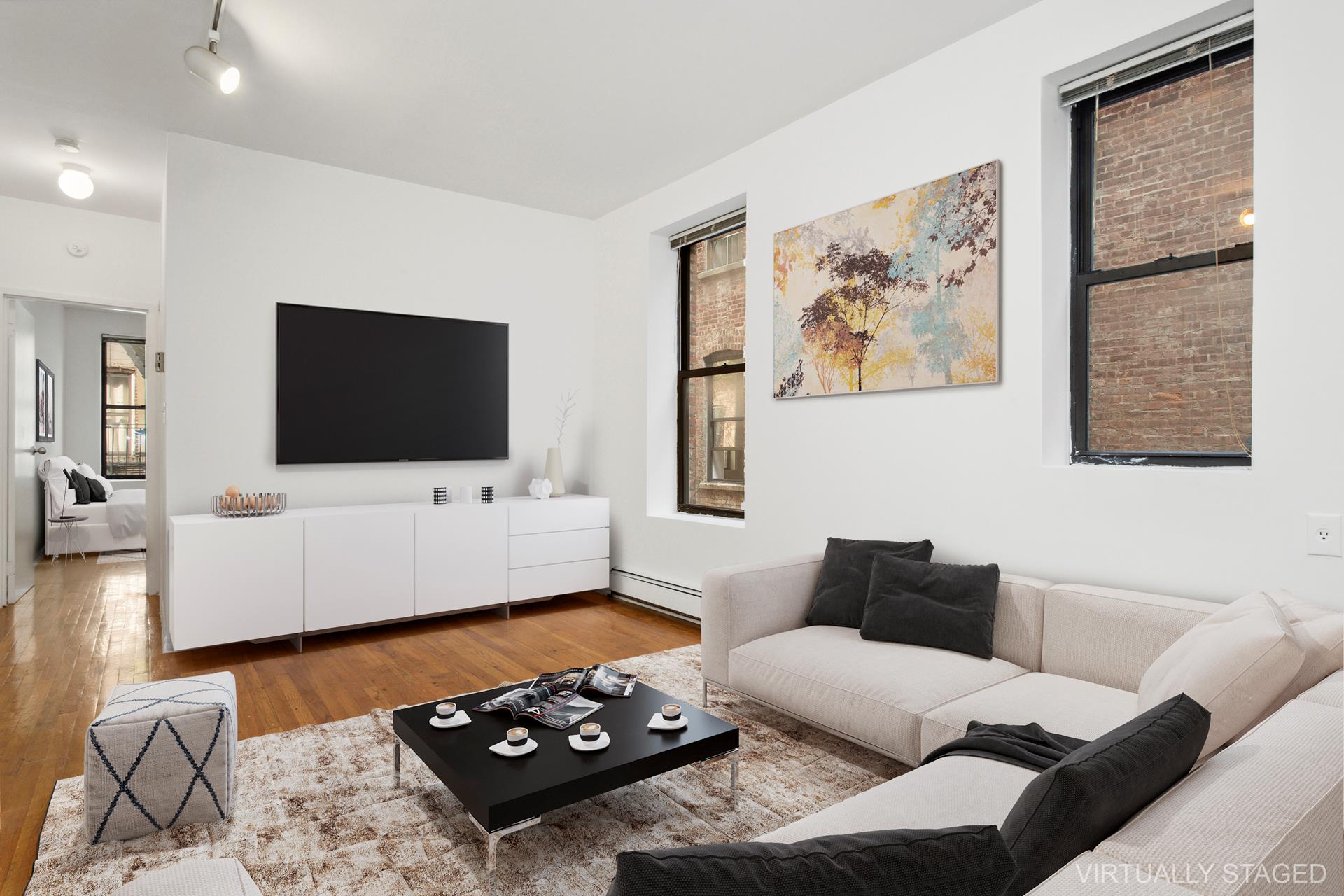 a living room with furniture and a flat screen tv