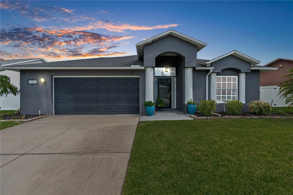 a front view of a house with a yard and garage