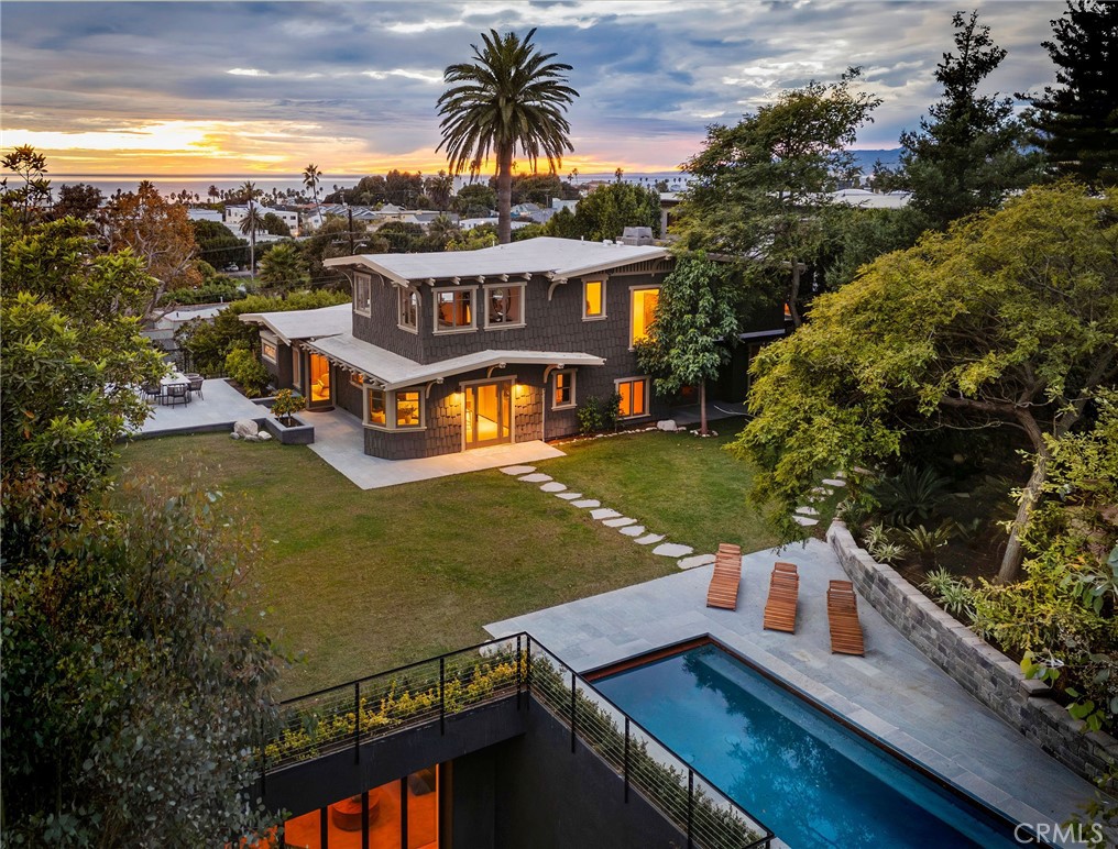 an aerial view of a house with swimming pool outdoor seating