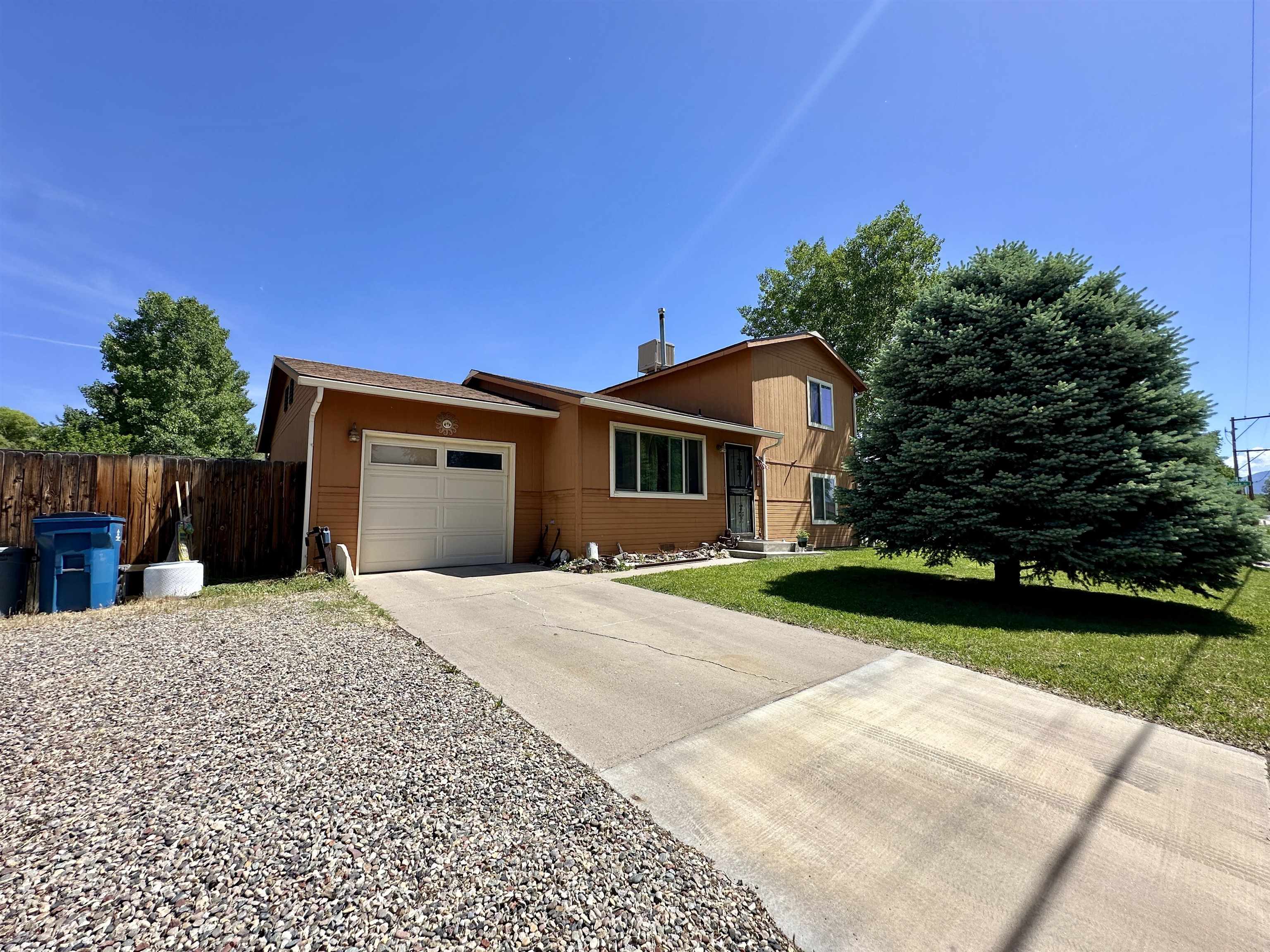 a front view of a house with a yard and a garage