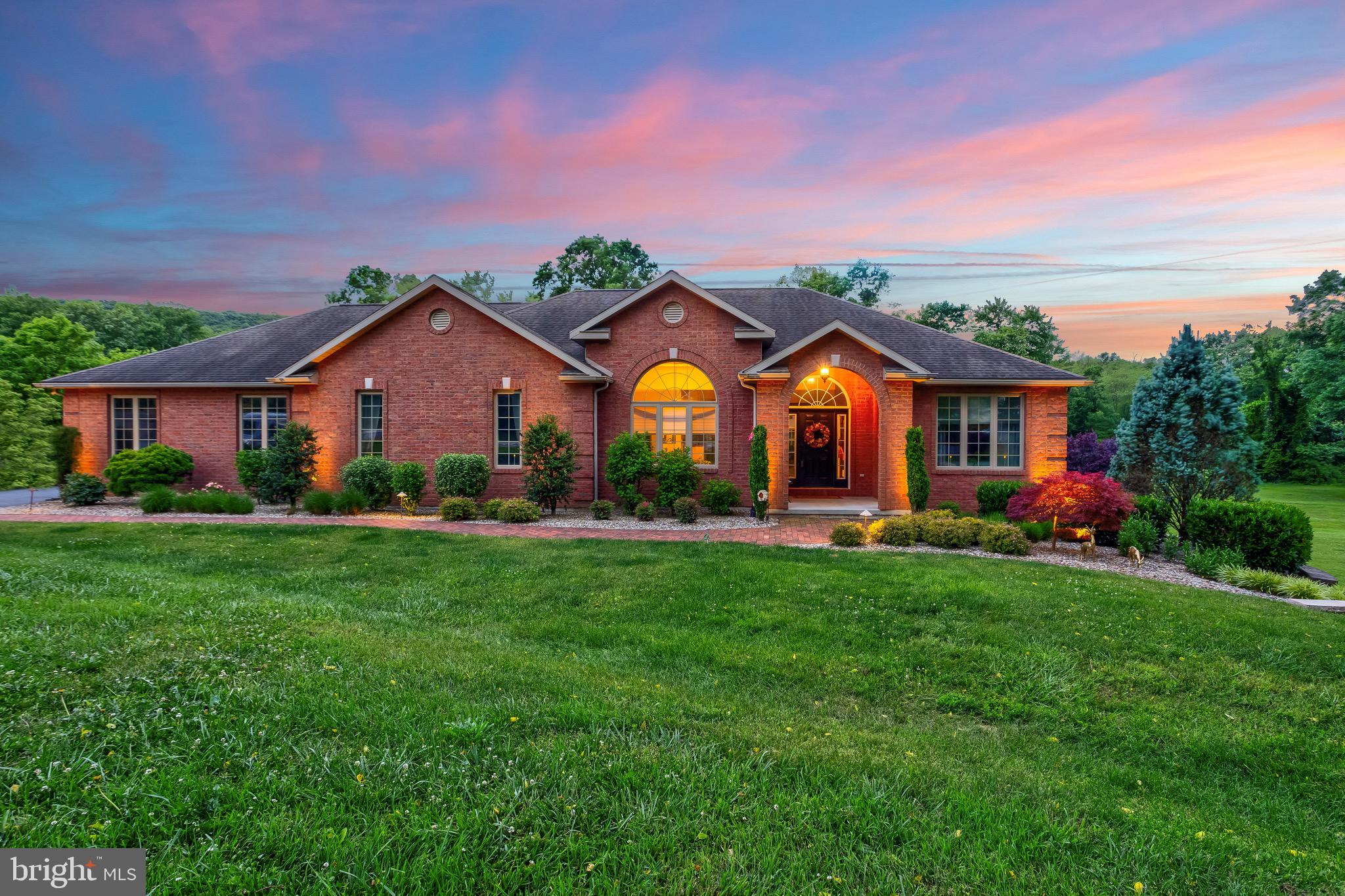 a view of a big house with a big yard and potted plants