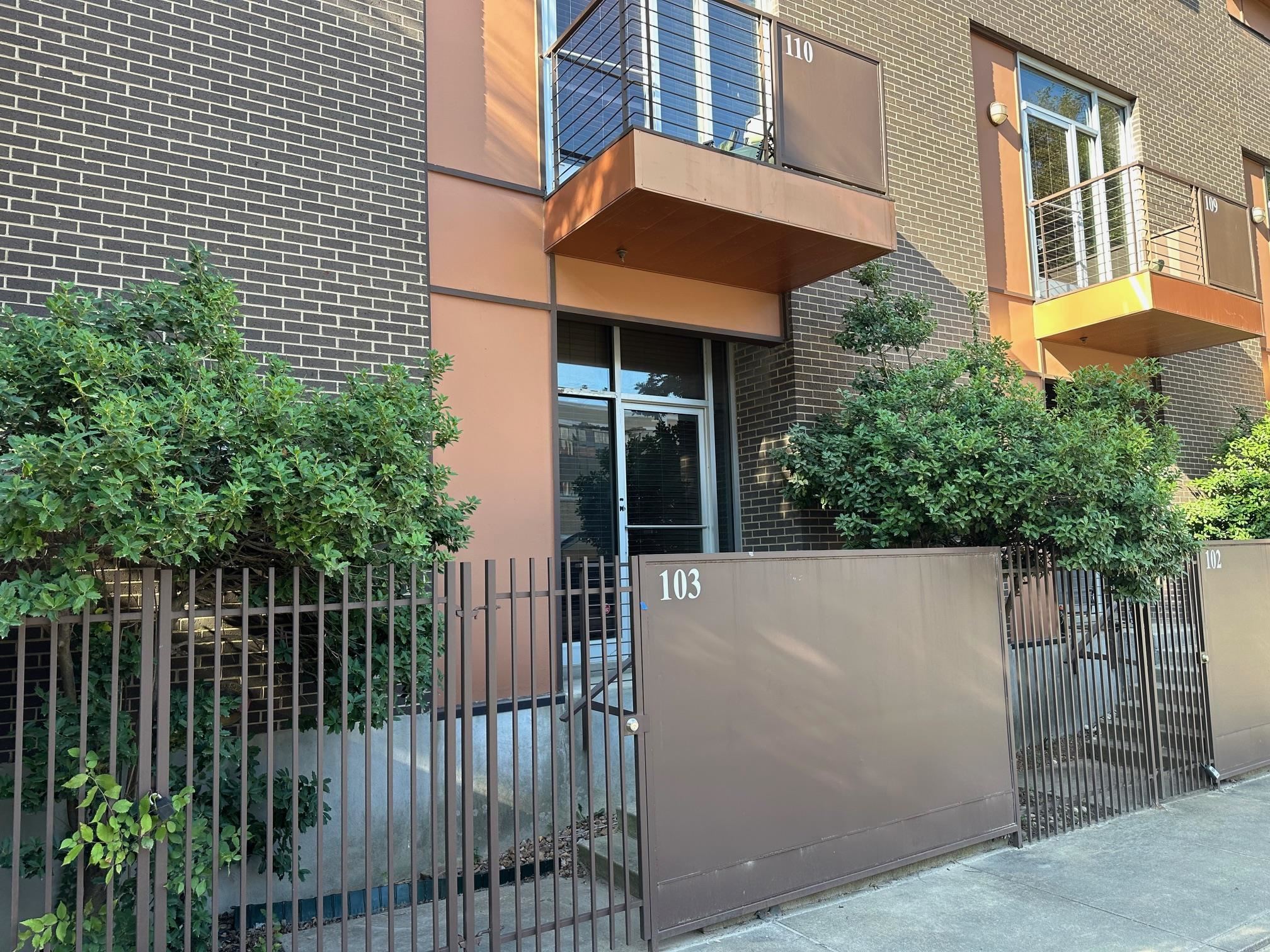 a view of a house with a small yard and plants