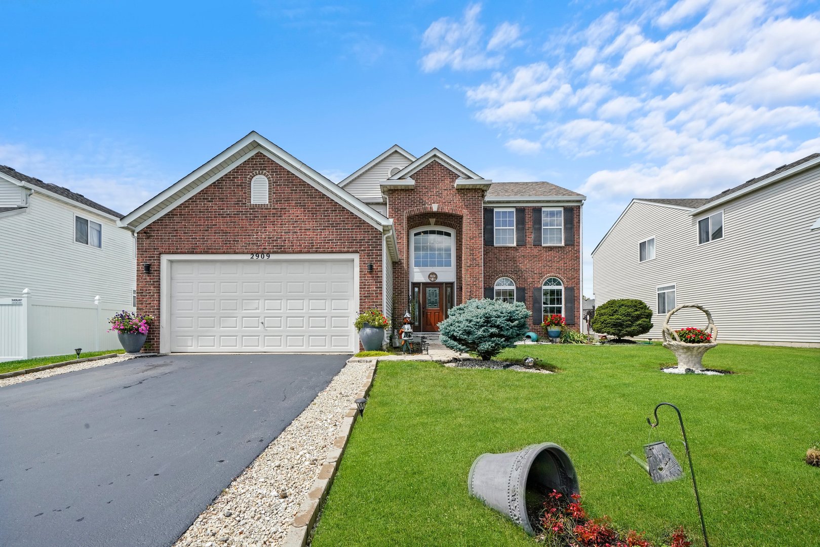 a front view of a house with a yard and garage