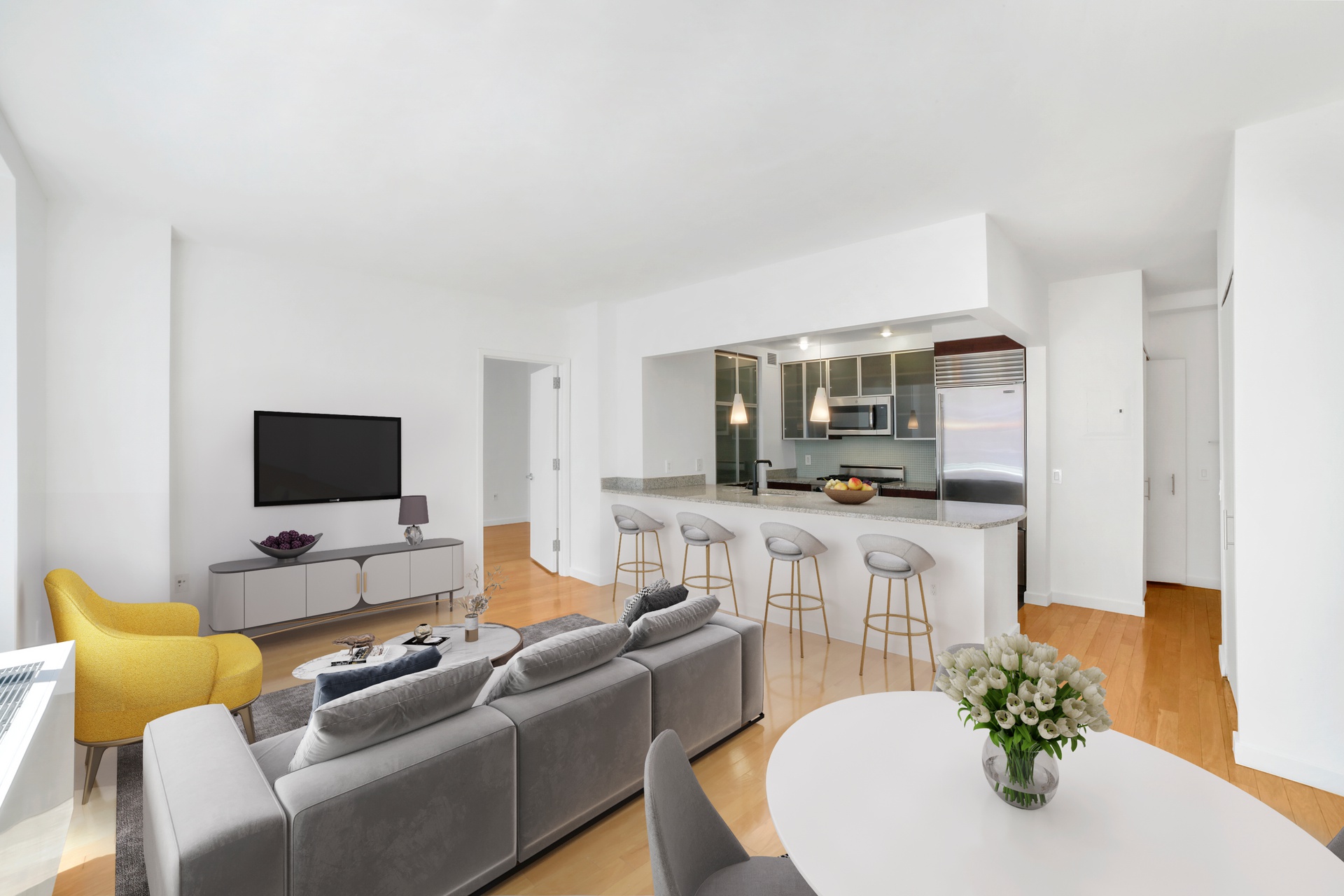 a living room with furniture kitchen view and a flat screen tv