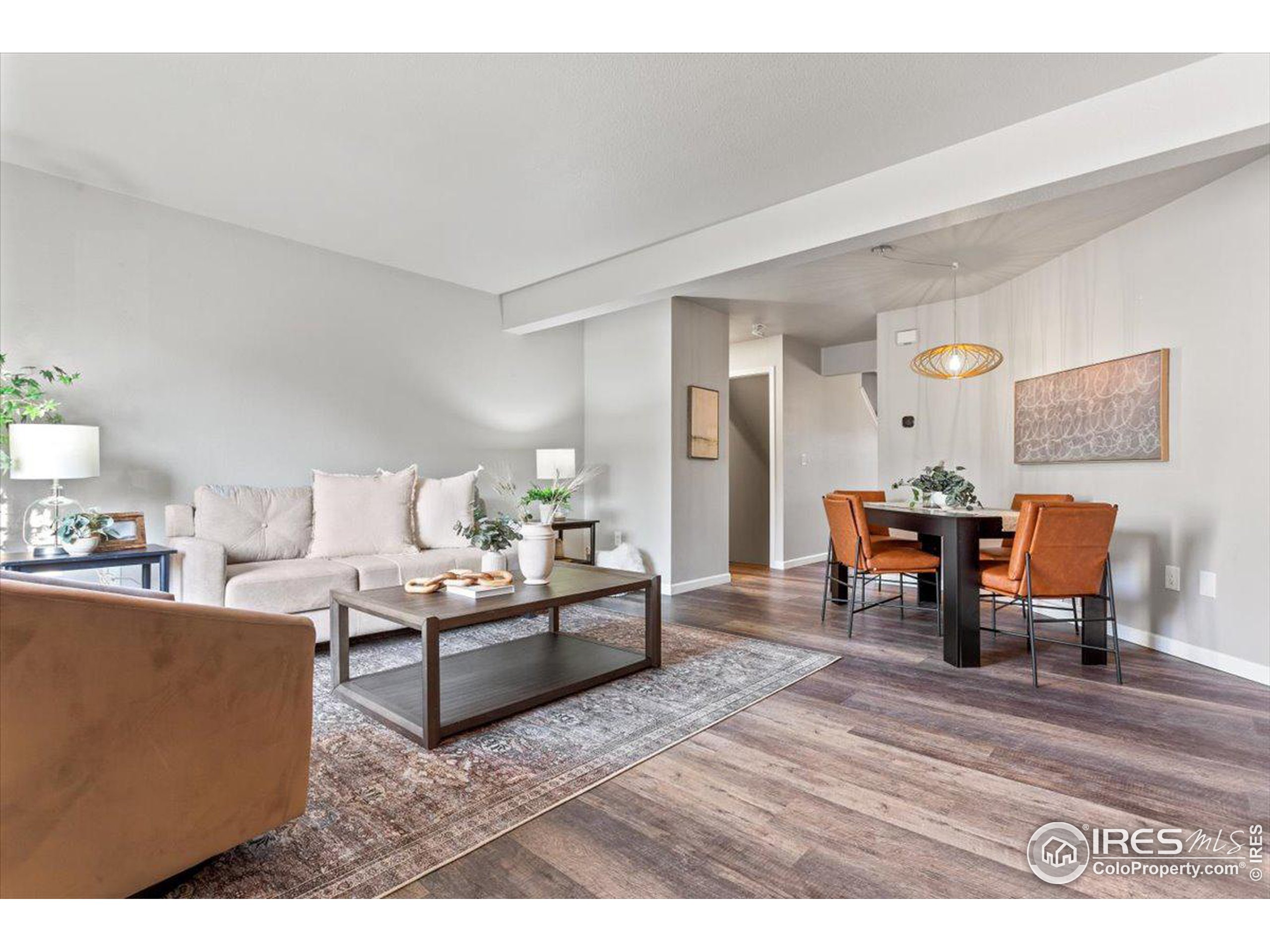 a living room with furniture and a dining table