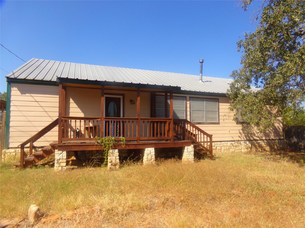 a view of a house with wooden deck