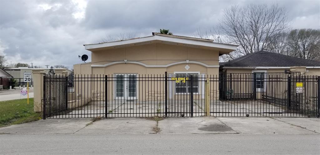 a view of a house with iron fence