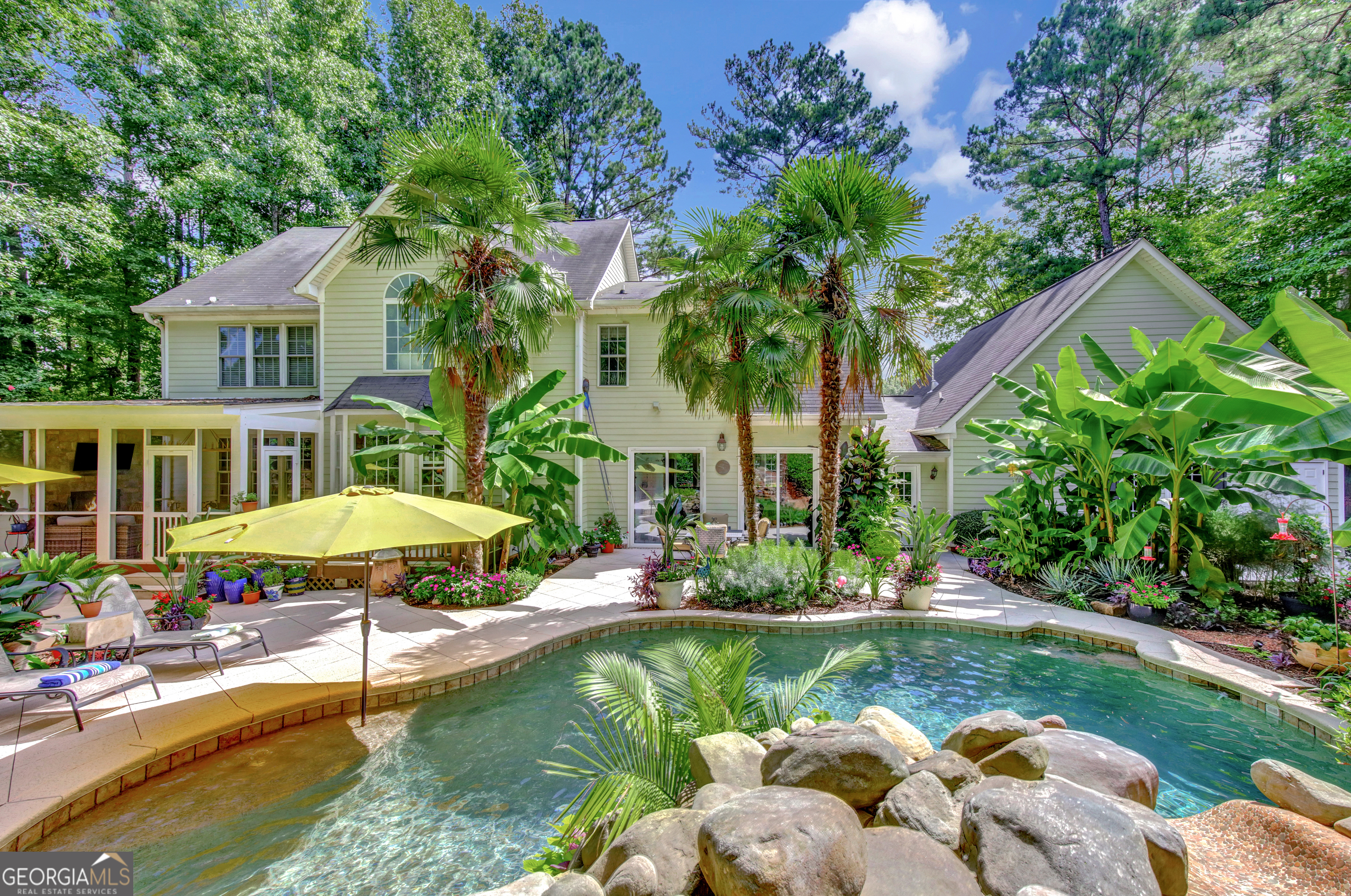 a view of a house with swimming pool and a yard