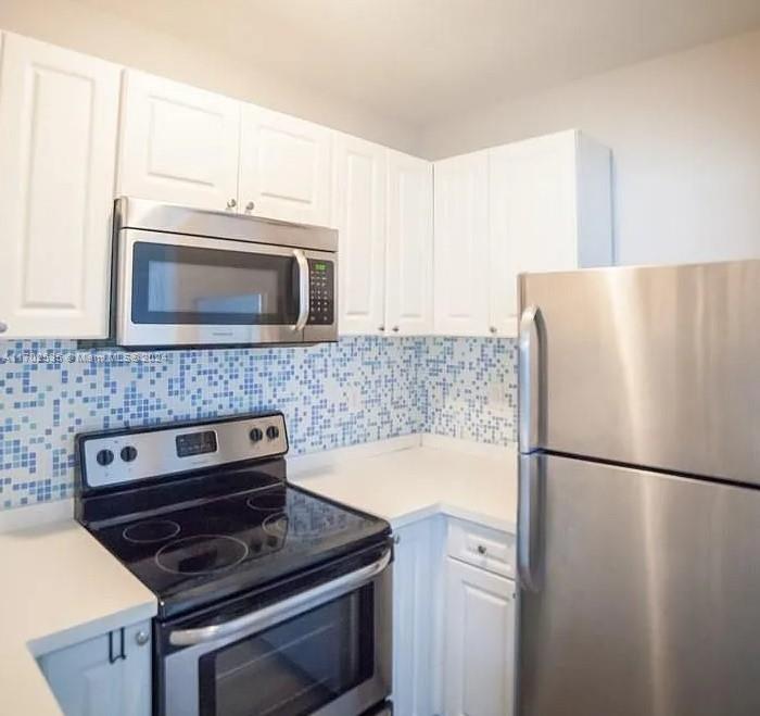 a kitchen with a stove and a microwave