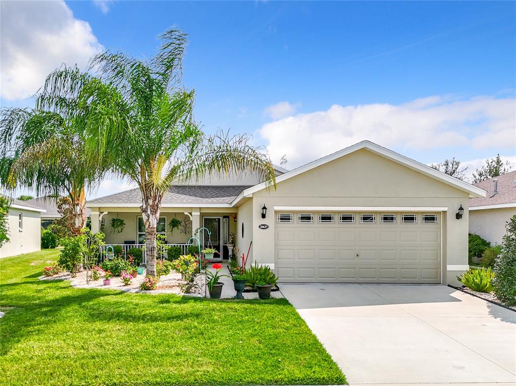 a front view of a house with a yard and garage