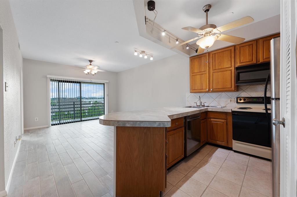 a kitchen with stainless steel appliances granite countertop a stove and cabinets