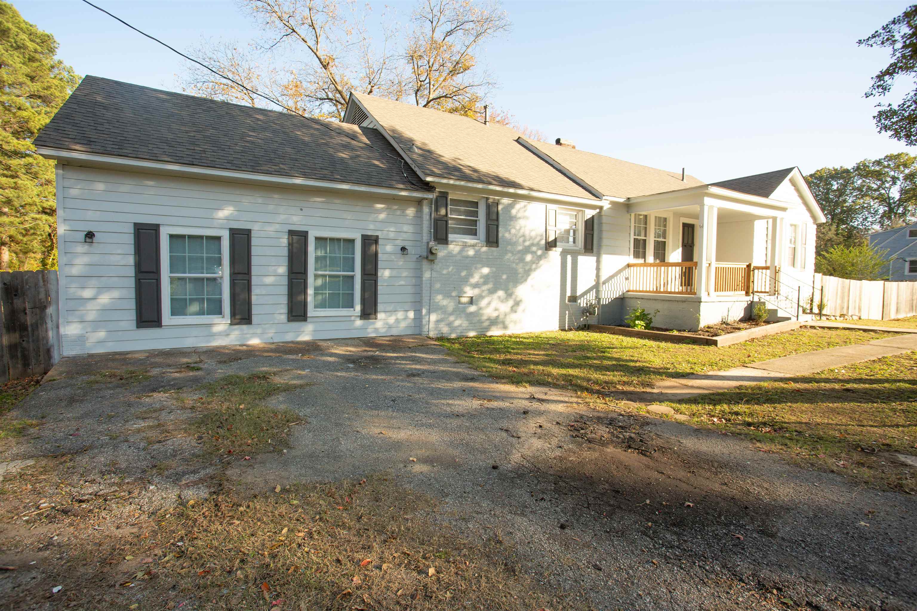 View of front of home with a porch and a front yard