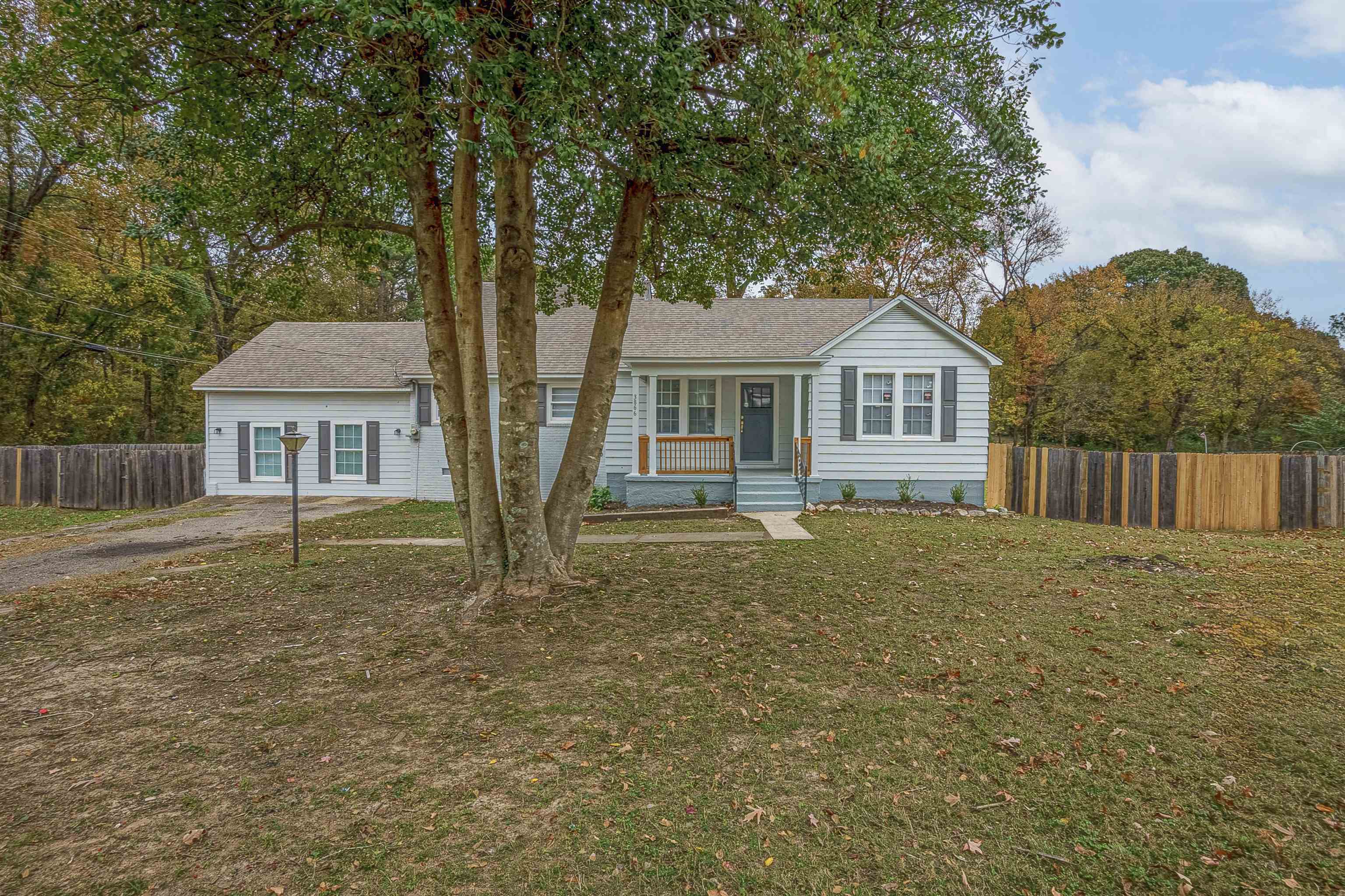 Single story home with a front lawn and a porch