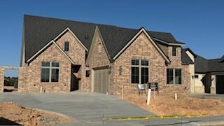 a view of a house next to a yard