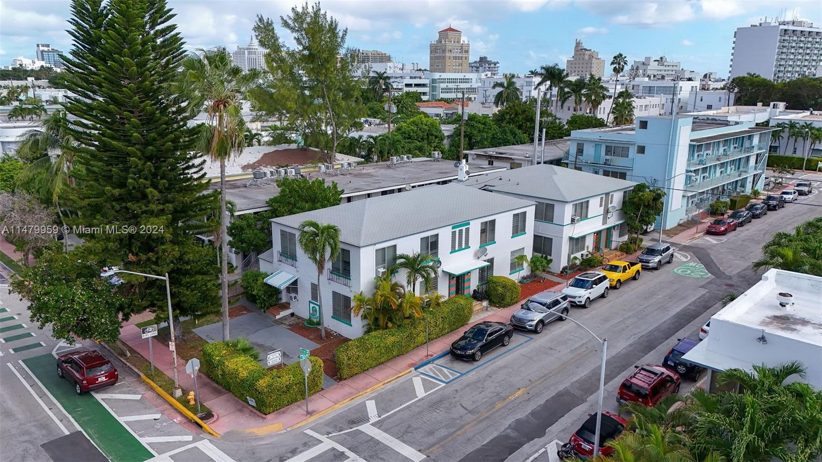 an aerial view of multiple houses with a yard