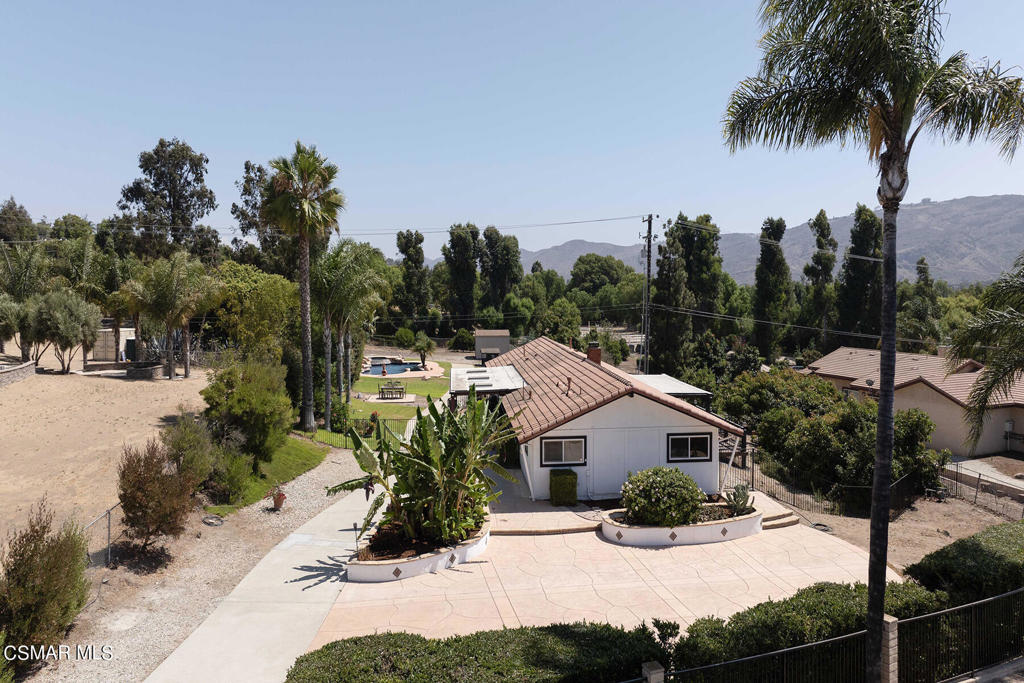 a view of a house with a yard patio and swimming pool