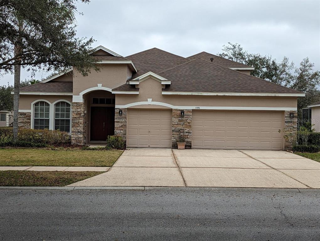 a front view of a house with a yard and garage