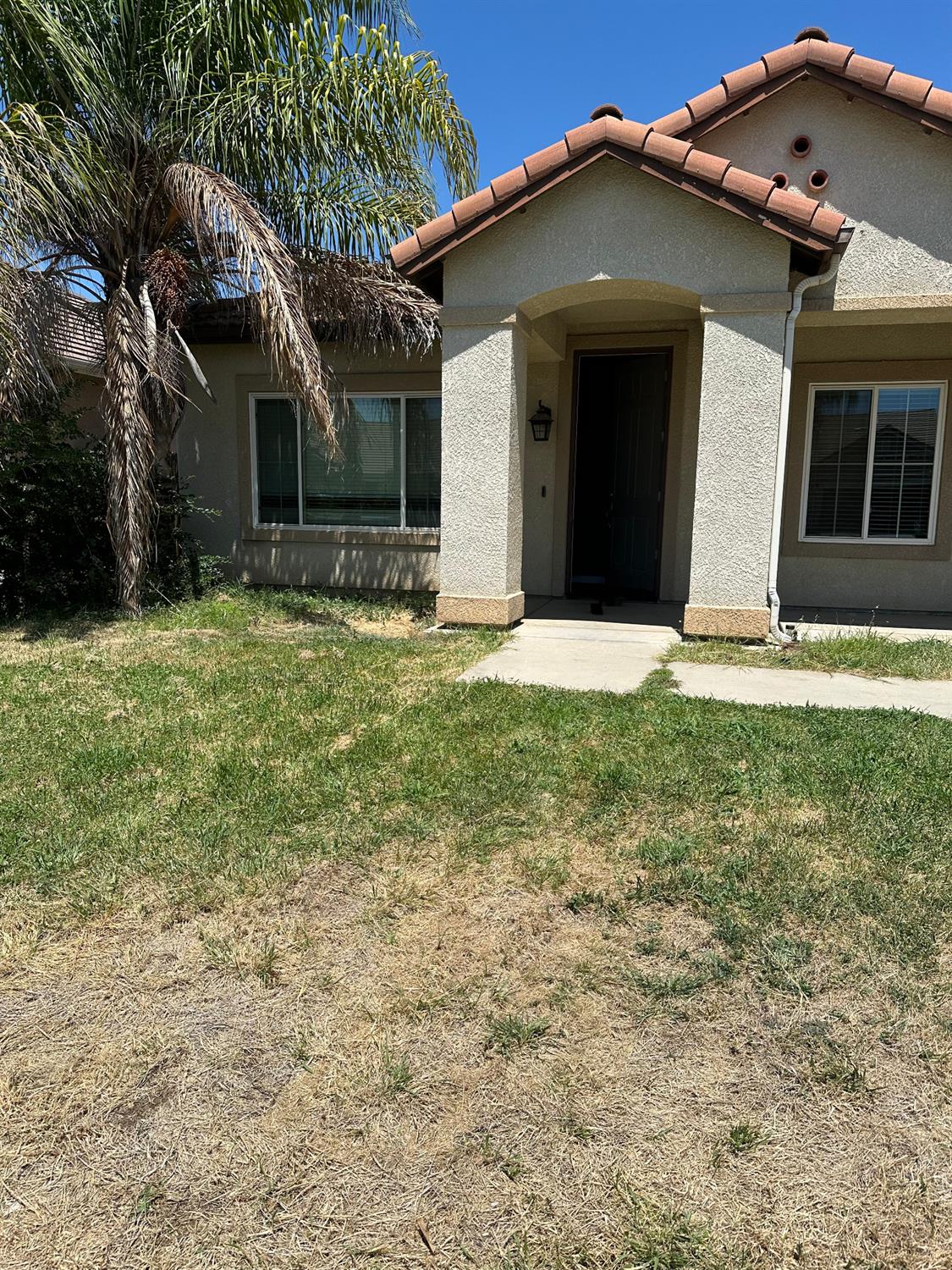 a front view of a house with a yard