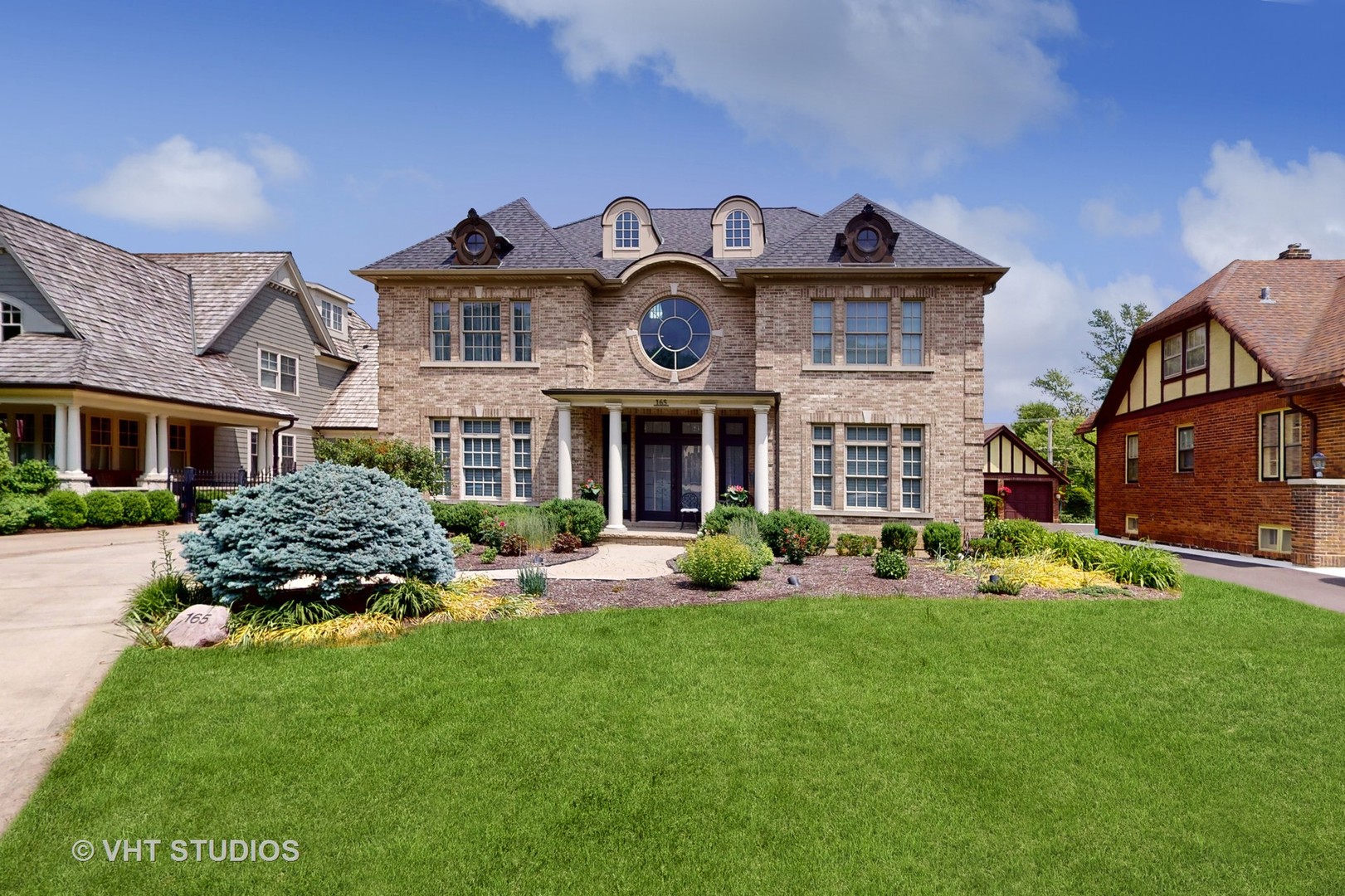 a front view of a house with garden