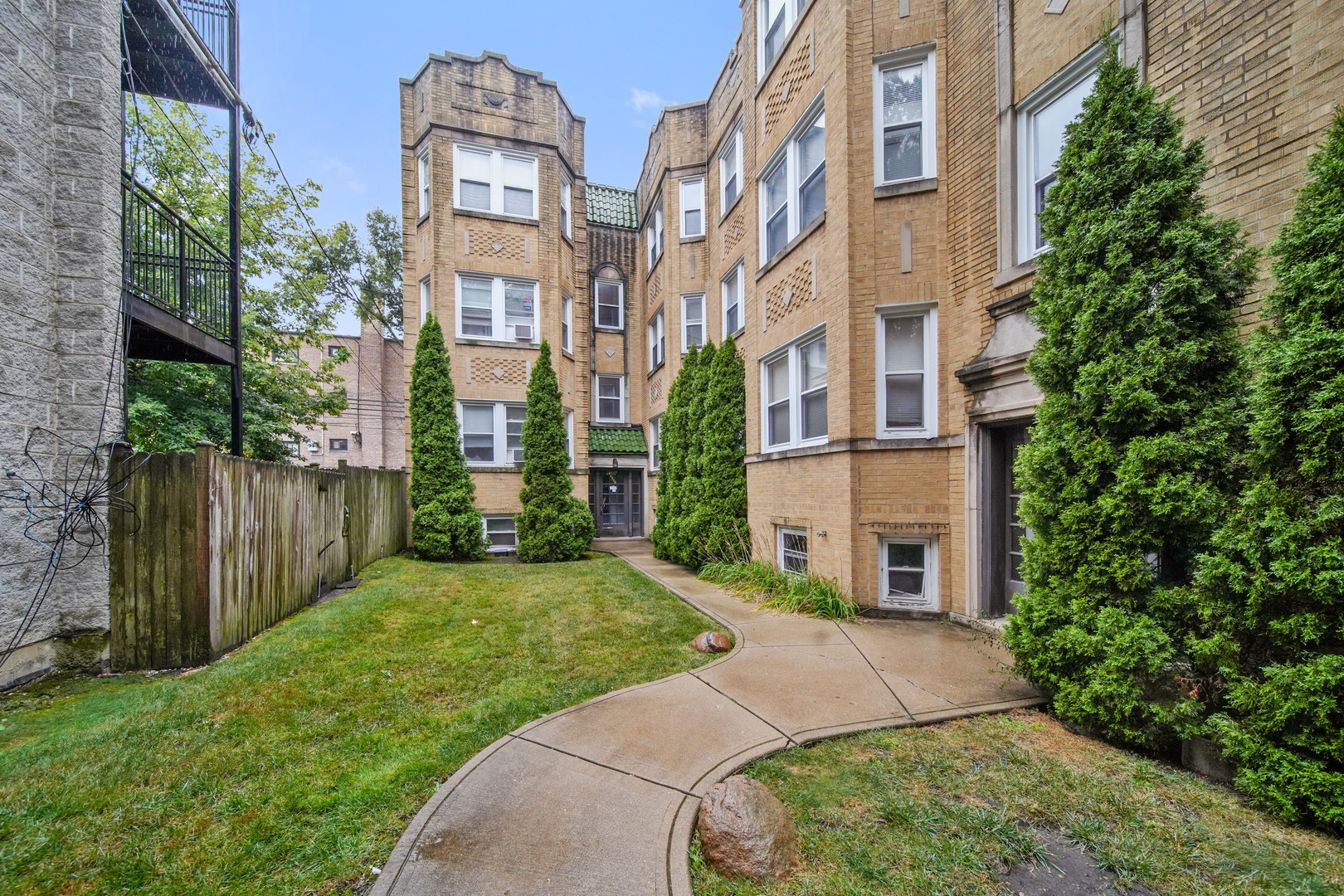 a view of a building with a yard