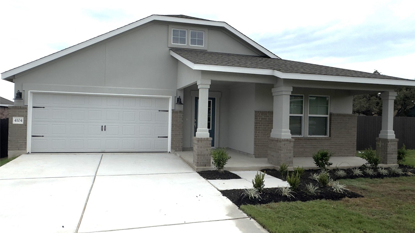 a front view of a house with garage