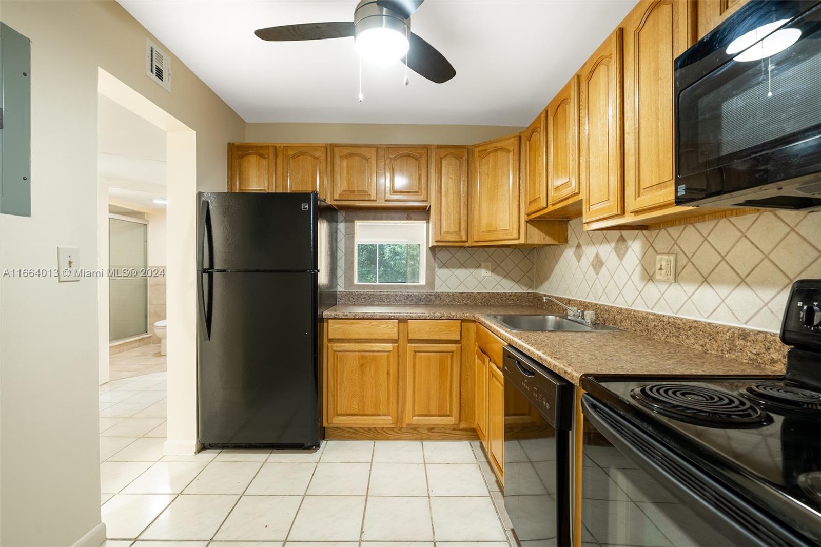 a kitchen with stainless steel appliances granite countertop a refrigerator and a stove