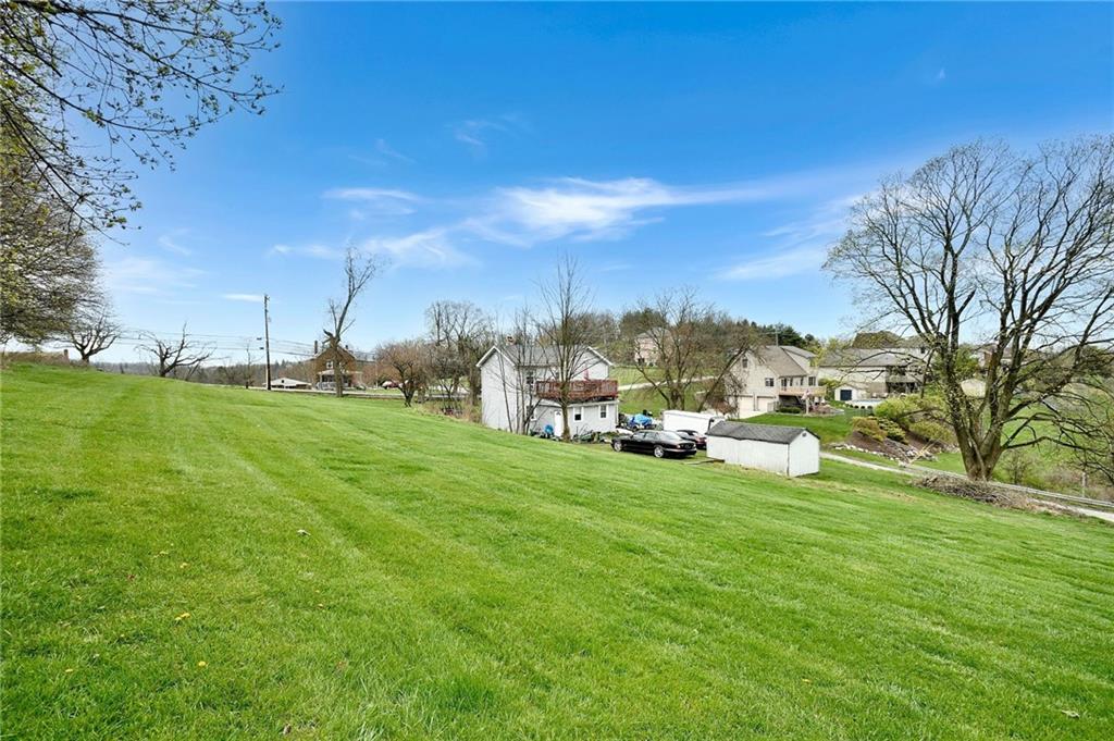 a view of yard with swimming pool and green space