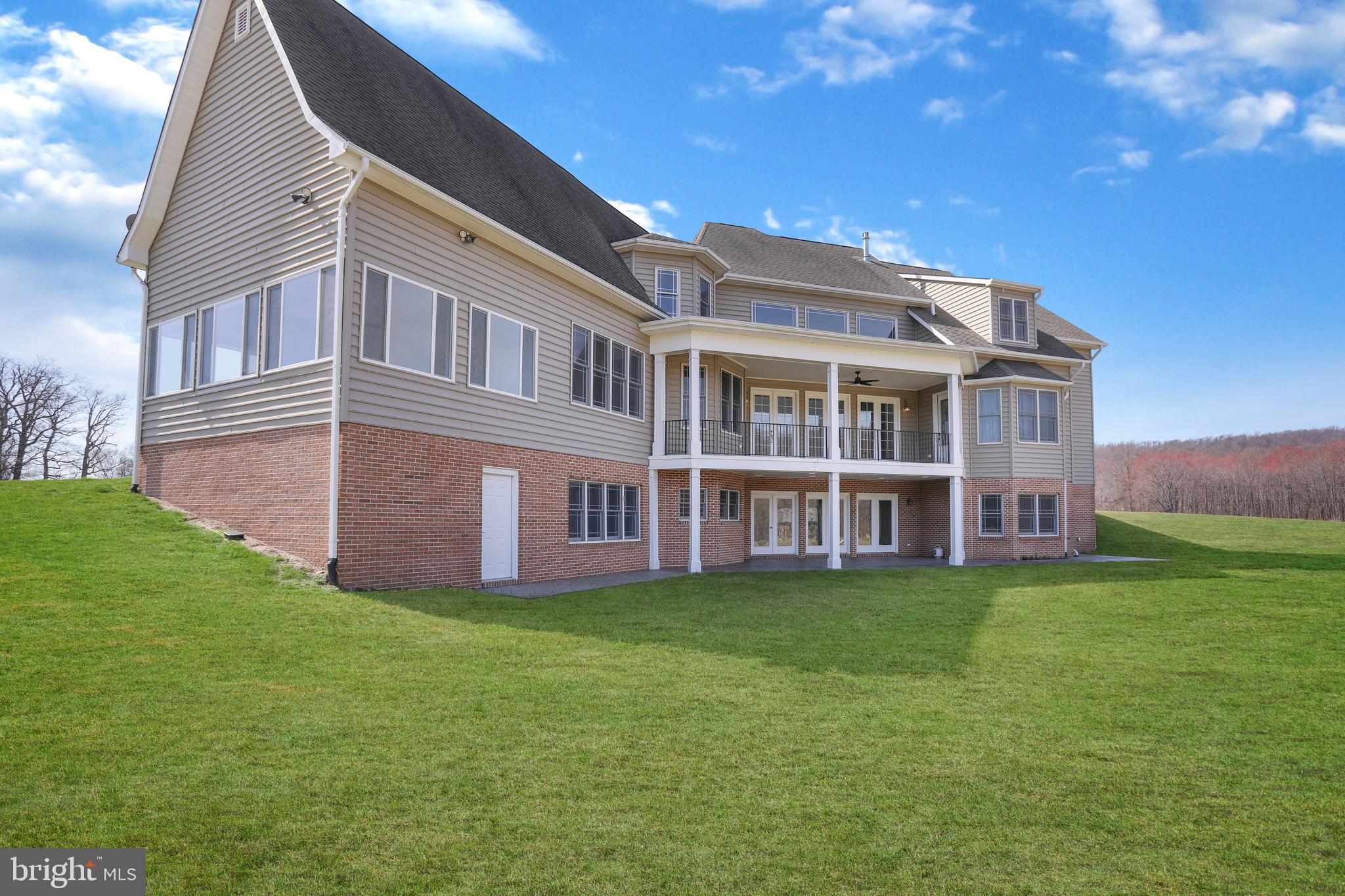 a view of a house with a yard and sitting area