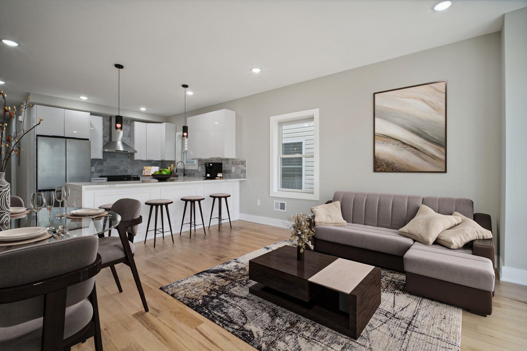 a living room with furniture and kitchen view