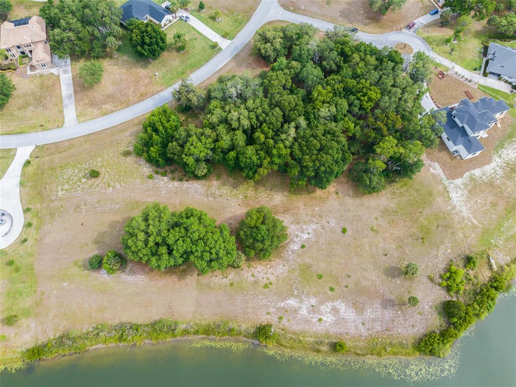 an aerial view of a houses with yard