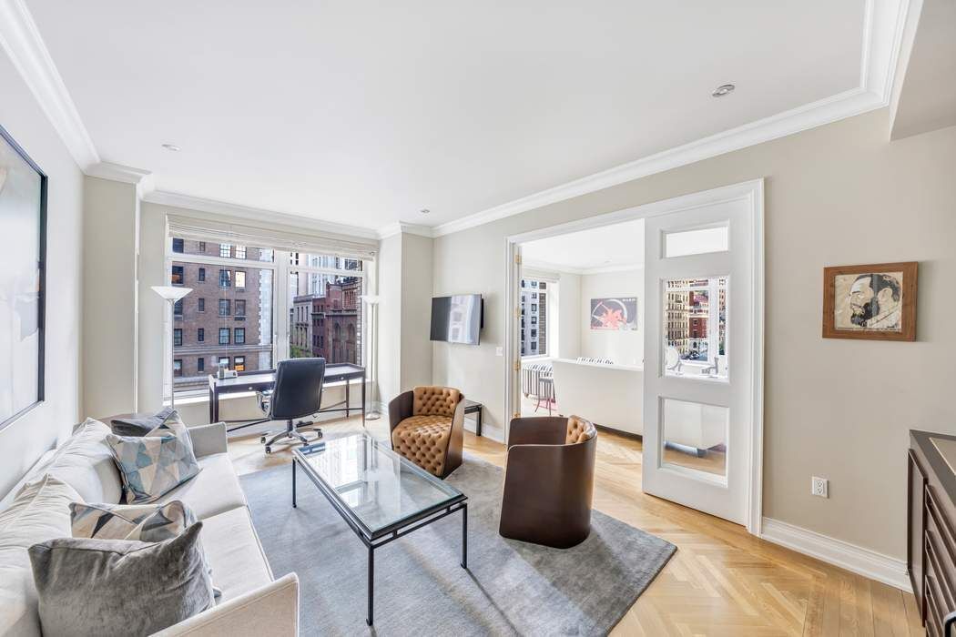 a living room with furniture and large window