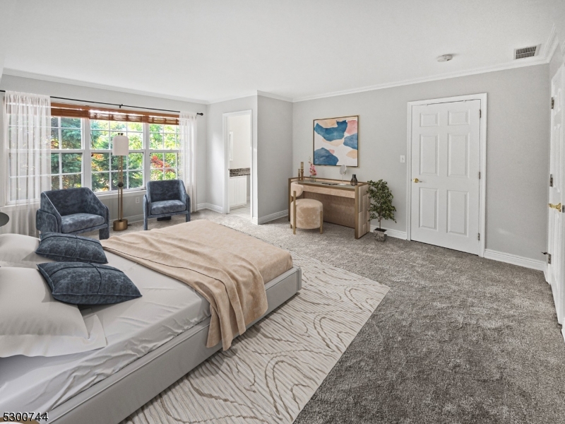 a spacious bedroom with a bed and glass window