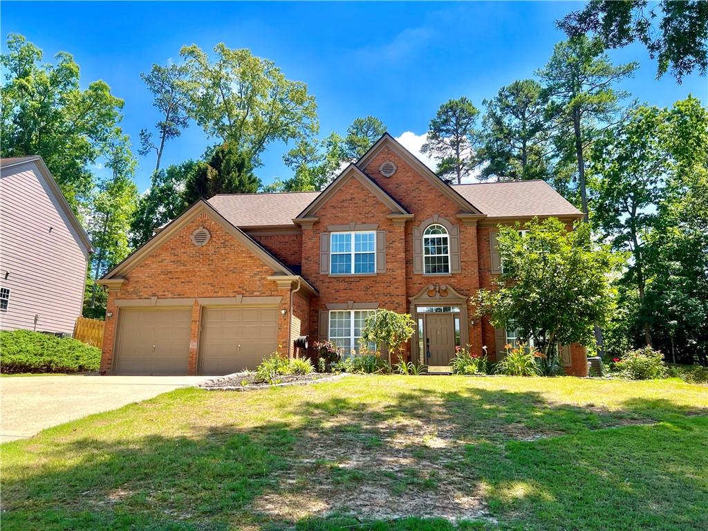 a front view of a house with a yard