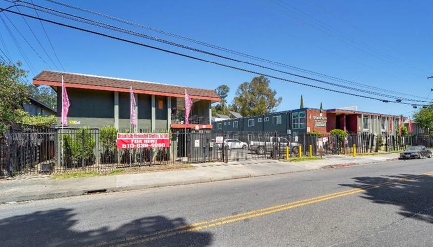 a view of a building with a yard