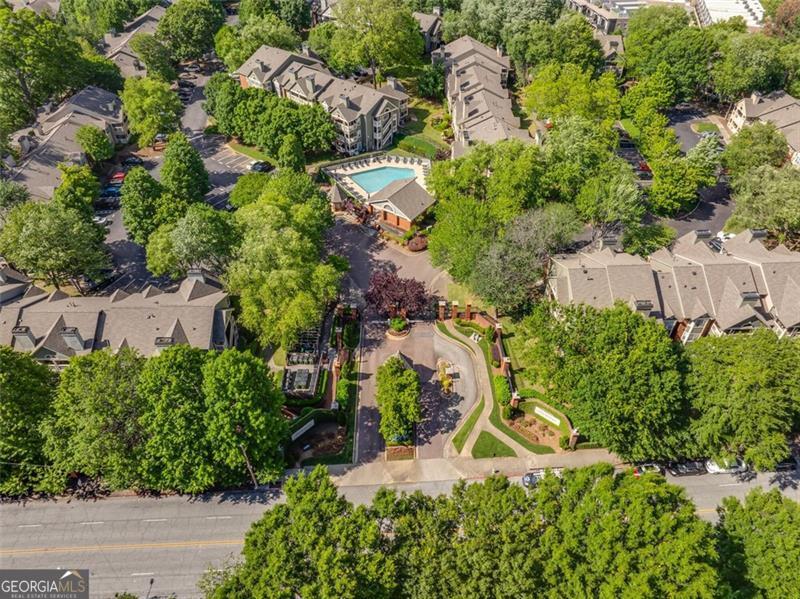 an aerial view of a house with a yard and greenery