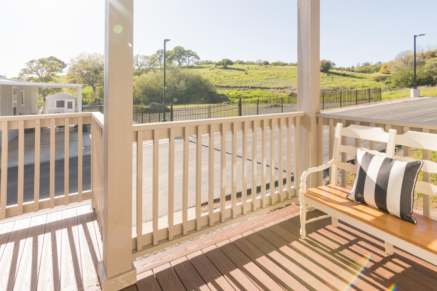 a view of a balcony with wooden floor