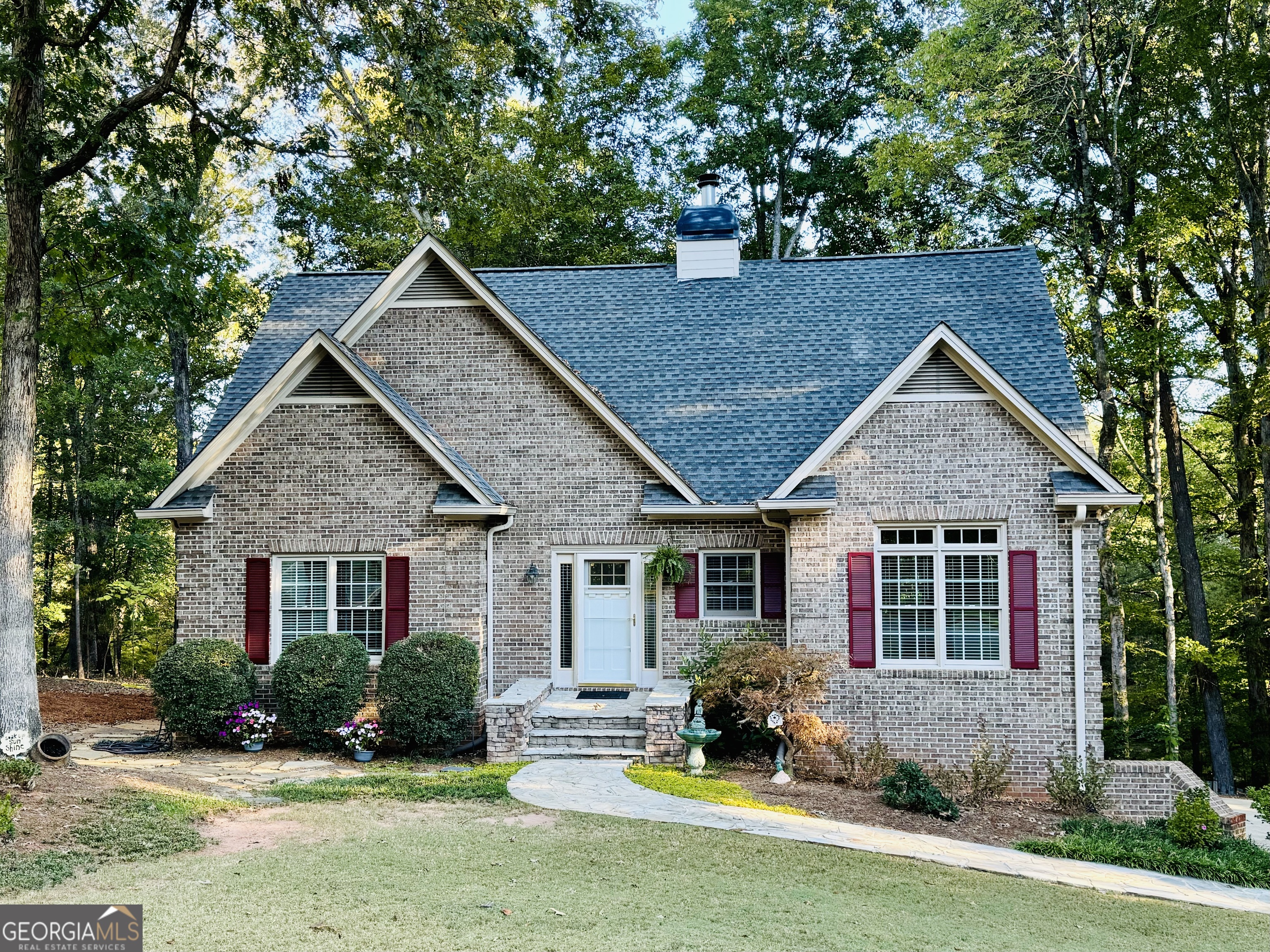 a front view of house with yard and green space