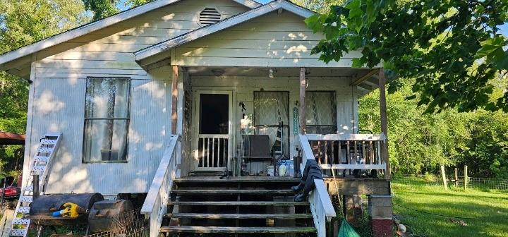 a view of house with yard