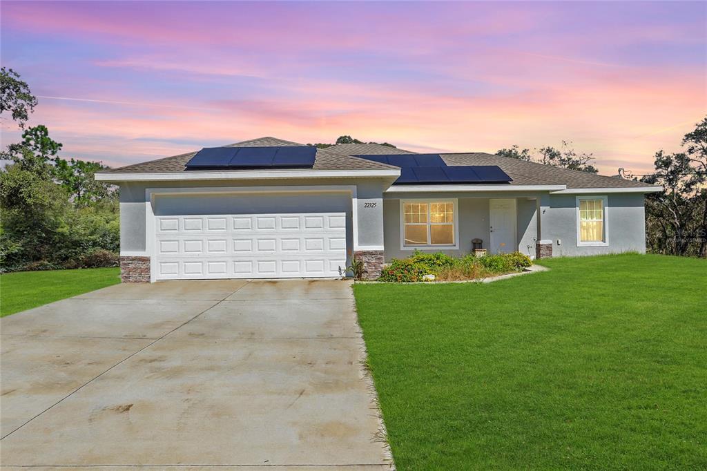 a front view of a house with a yard and garage