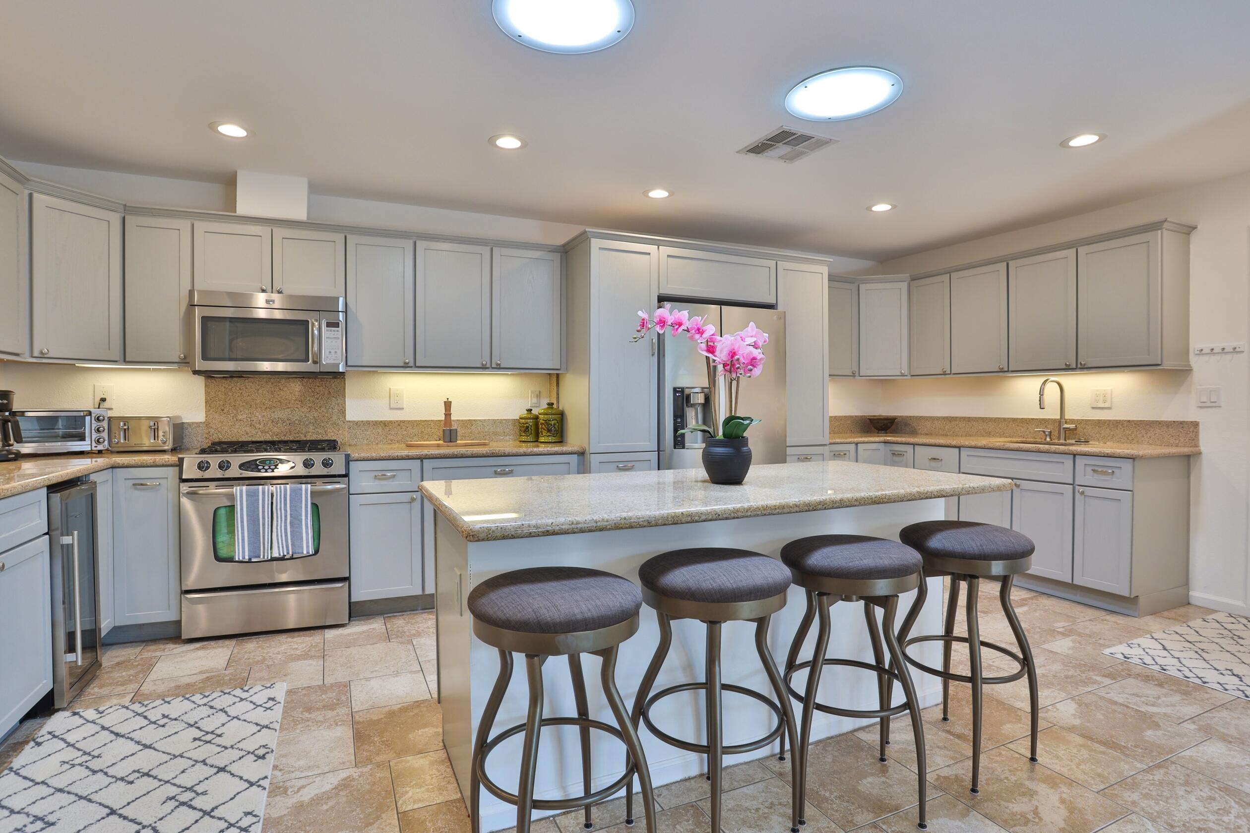 a kitchen with granite countertop a counter top space appliances and cabinets