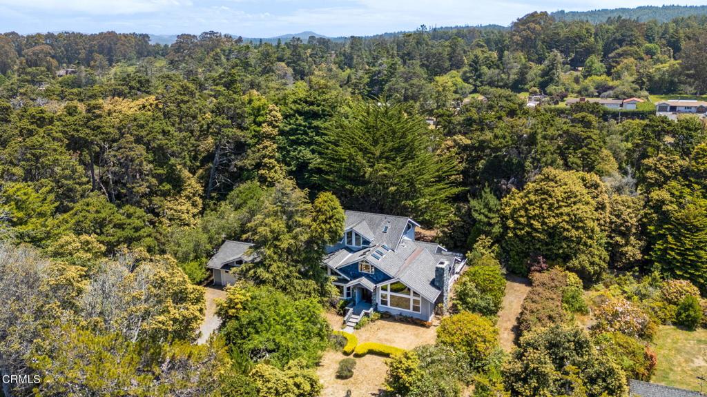 an aerial view of a house with a yard