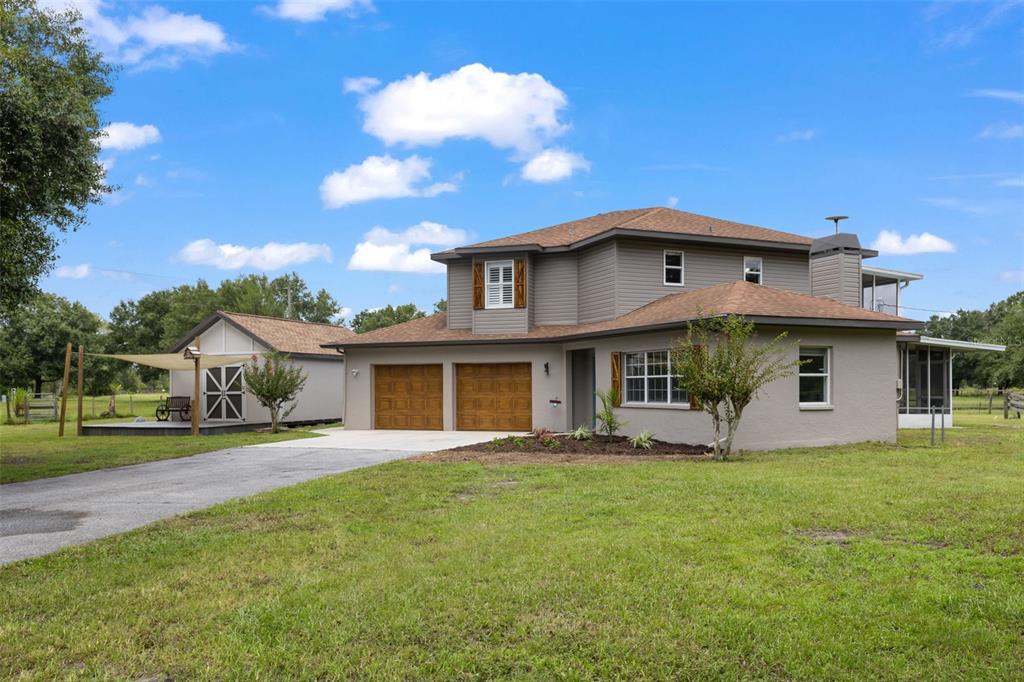 a front view of house with yard and green space