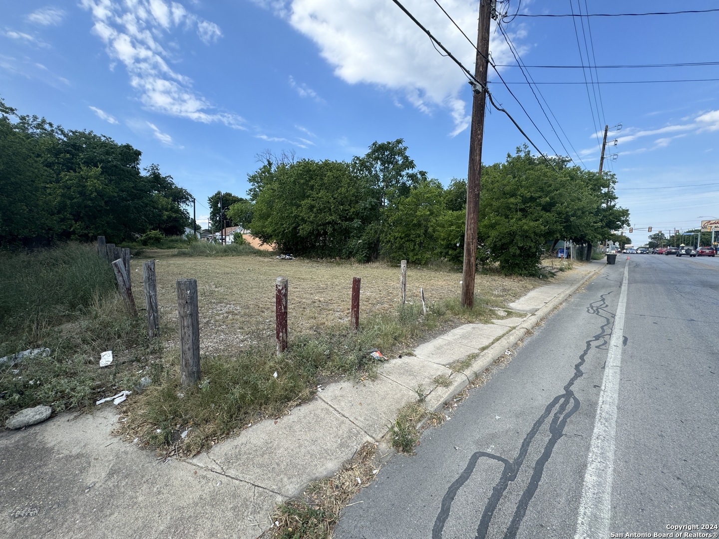 a view of a pathway with a wrought fence