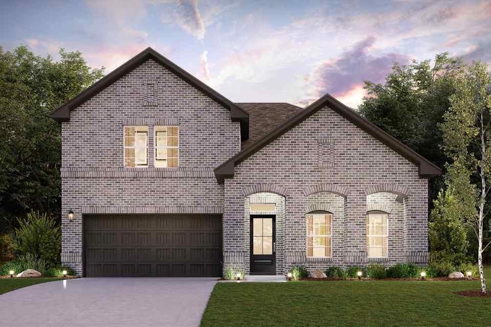 a front view of a house with a garden and garage