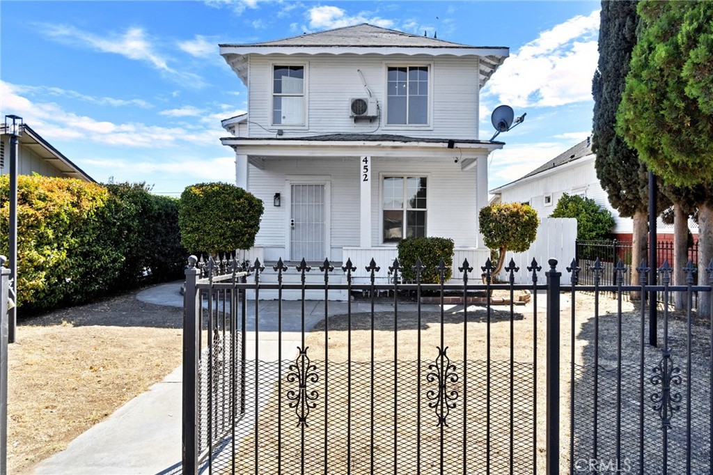 a front view of a house with wooden fence