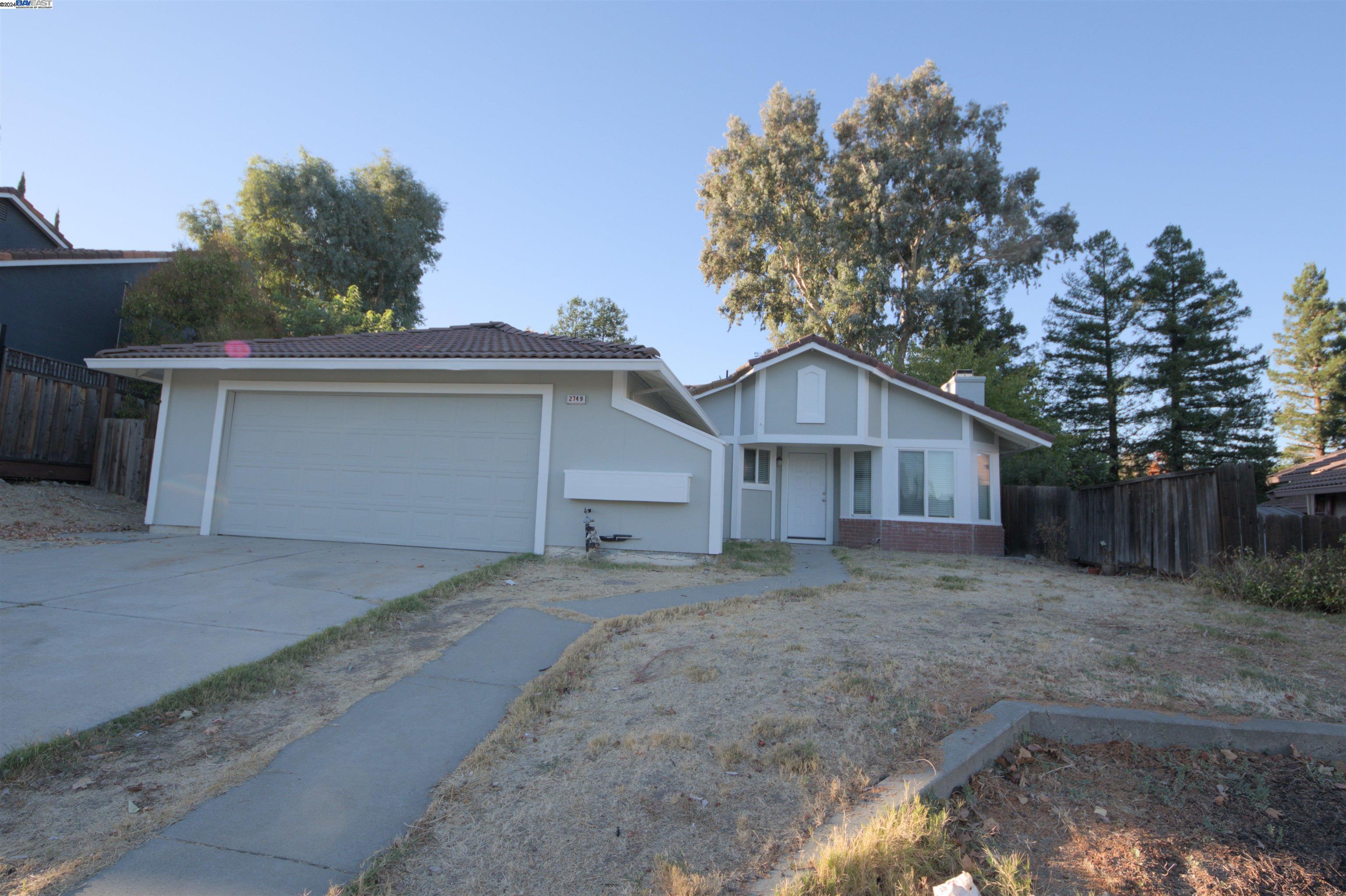 a view of a house with a yard and garage