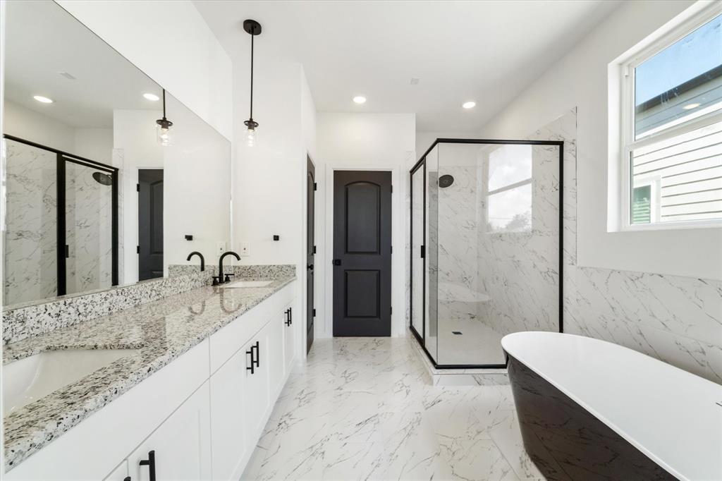 a bathroom with a granite countertop tub sink and shower