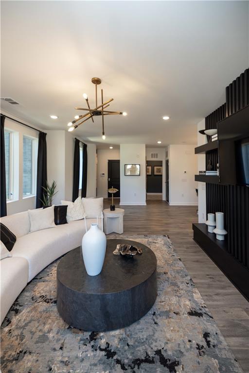 a living room with furniture and kitchen view