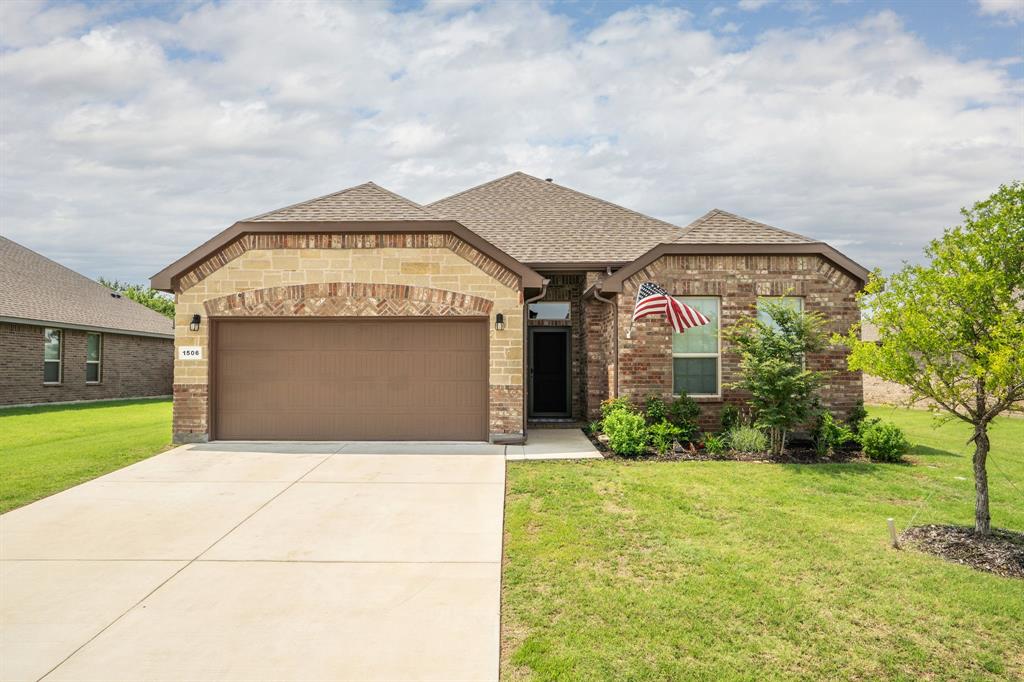 a front view of a house with a yard and garage