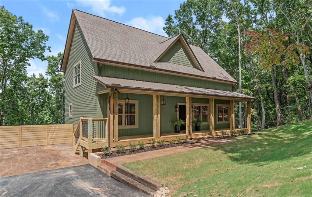 a view of a house with backyard and porch